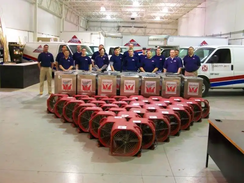 Team photo next to restoration equipment